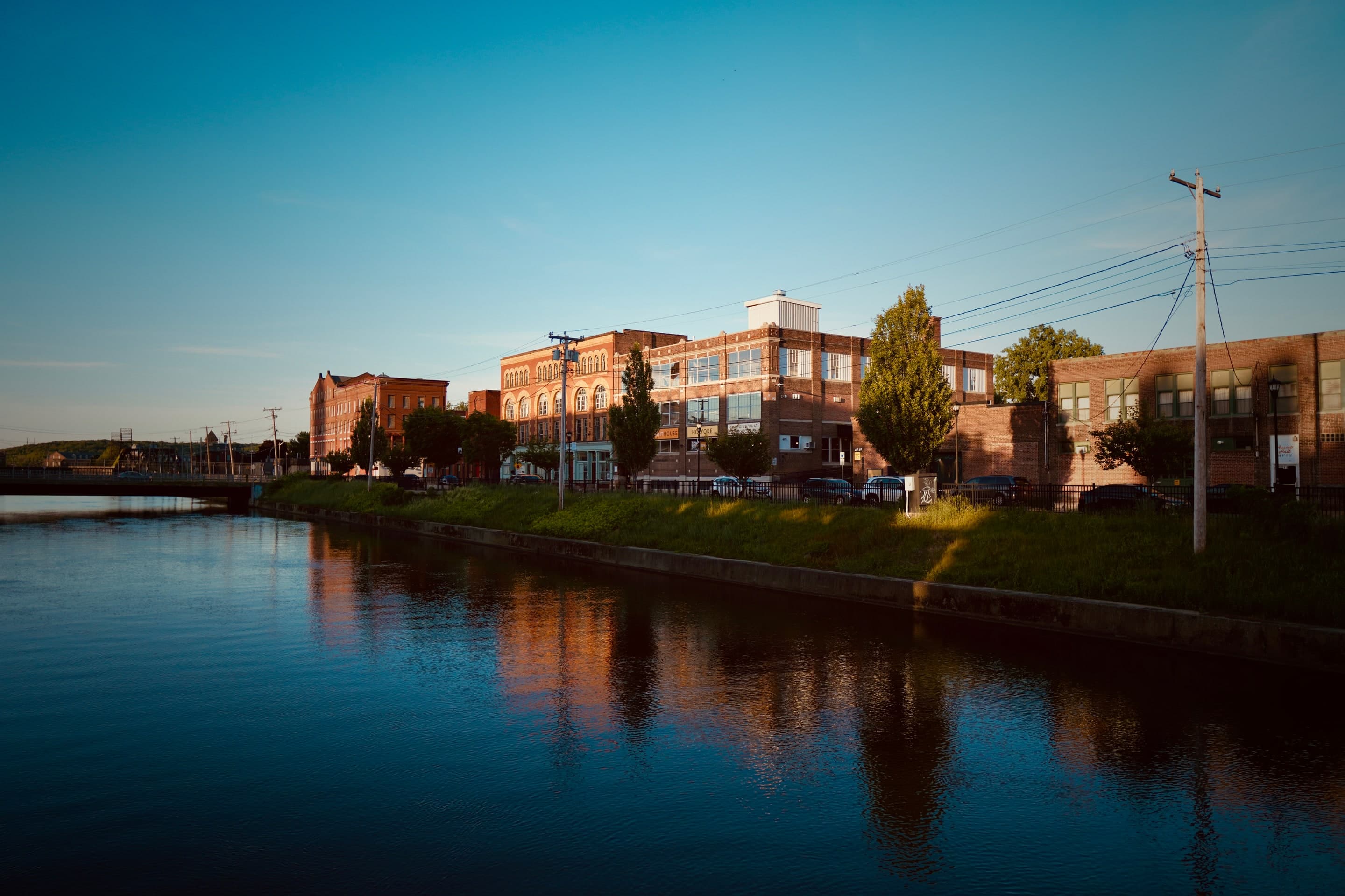Golden evening light on the canal beside the Creators Campus buildings in Holyoke's Canal District